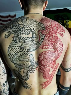 a man with dragon tattoos on his back