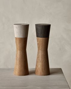 two wooden vases sitting on top of a table