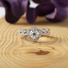 a diamond ring sitting on top of a wooden table