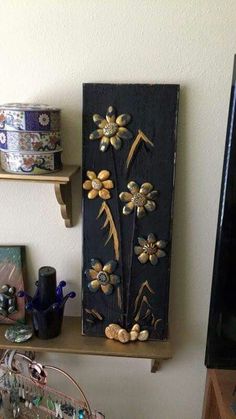 a wooden shelf with two shelves holding jewelry and other items on it, along with a television