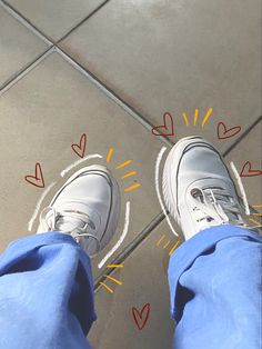 someone standing in front of a tile floor with hearts drawn on it and arrows pointing to the left