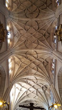 the inside of a large cathedral with a crucifix in it's center