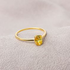 Our yellow topaz ring has a stylish design and is suitable for daily use. A nice gift that can make you and your loved ones happy. Yellow Topaz is one of the strong and  healing stones. F E A T U R E S * Made to Order. * Gold KT: 14K * Gold Color: Yellow Gold, Rose Gold, White Gold * Yellow Topaz Carat: 0.70 ct. * Stone Height: 7,00 mm / 0.28 inch * Stone Width: 5,00 mm / 0.20 inch * Setting Type: Bezel Setting * Ready to Ship in 1-3 Business Days * 100% US sourced * 2 Years Warranty * Free Express International Shipping * Free returns within 14 days from the order date Oval Cut 14K Solid Gold Yellow Topaz Ring, Mother's Day Gift, 14K Gold Birthstone Ring, Oval Cut  Ring, Women's Jewelry, Minimalist Ring We loved making our jewelry with special designs for your special moments. Wishing you Yellow Topaz Ring For Women, Gold Minimalist Topaz Promise Ring, Minimalist Topaz Rings As Gifts, Gift Yellow Gold Topaz Ring With Cubic Zirconia, Yellow Gold Topaz Ring With Cubic Zirconia For Gift, Yellow Topaz Promise Ring In 14k Gold, Minimalist Gold Topaz Ring As Gift, Minimalist Gold Topaz Ring Gift, Yellow Crystal Ring For Promise