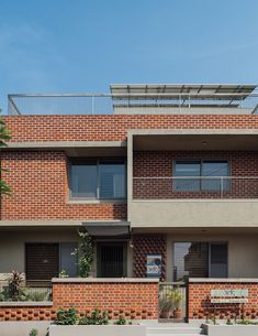 an apartment building with balconies and brick walls