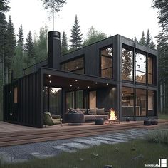 a house made out of shipping containers sitting on top of a wooden deck next to a fire pit