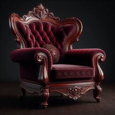 an ornately decorated red chair in a dark room with wood floors and flooring