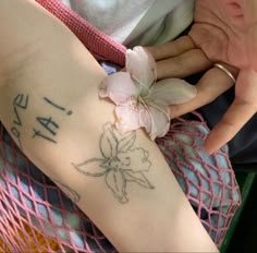 a woman with a flower on her arm and the word la vie is written in cursive ink