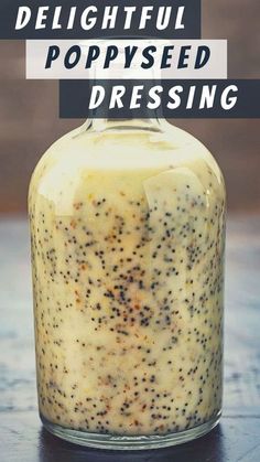 a jar filled with poppy seed dressing sitting on top of a table