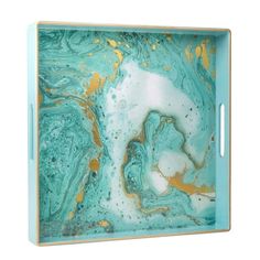 a blue and gold tray with marbled designs on the bottom, in front of a white background