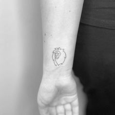 a woman's arm with a small tattoo on it