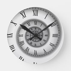 a white clock with roman numerals on the face