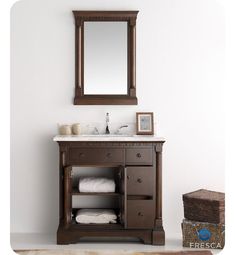 a bathroom vanity with a mirror above it and towels on the shelf next to it