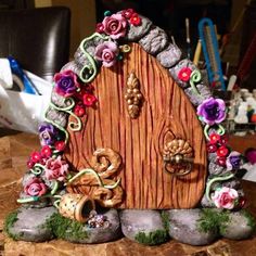 a fairy house made out of rocks and flowers