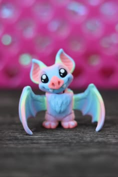 a small toy bat sitting on top of a wooden table