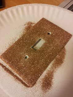 a white plate topped with a brown piece of food on top of a wooden table