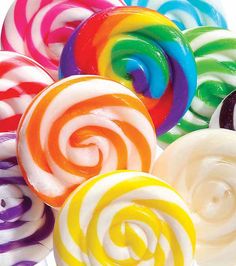 many different colored lollipops on a white background