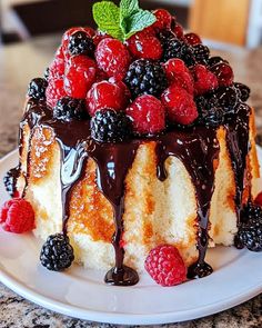 a cake with chocolate sauce and berries on top