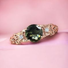 This Ring is Made With a Round Cut Lab Made Moldavite Gemstone and the rest accented stone in this ring, are the Authentic Moissanite to adorn the look of this beautiful Ring. Such a unique piece to wear occasionally or can be used regularly. Can be used to gift your loved ones, to make feel them feel special. MATERIAL AVAILABILITY- ( 925 Sterling Silver/ 14k solid gold(white gold / rose gold / yellow gold ) Item Information: Center Stone Type: Lab Made Moldavite Gemstone Center Stone Shape: Round Cut Center Stone Size: 7x7mm (1.2carat) Cutting:Excellent Secondary Stone Type: Moissanites Gemstone Grade - AAA+ Occasions - engagement, wedding, birthday, anniversary, gift, Product Category: Engagement Ring/Wedding Ring/Promise Ring/Anniversary Gift Condition: Made to order We are Focused on o Luxury Emerald Ring With Gemstone Accents For Wedding, Luxury Tourmaline Rings For Anniversary, Luxury Birthstone Ring With Gemstone Accents, Wedding Jewelry With Tourmaline Center Stone, Tourmaline Ring With Accent Stones Jewelry, Exquisite Sapphire Ring With Gemstone Accents For Anniversary, Wedding Tourmaline Jewelry With Prong Setting, Elegant Topaz Ring With Accent Stones For May Birthstone, Luxury Jewelry With Accent Stones And May Birthstone