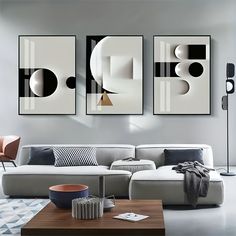 a living room with three paintings on the wall