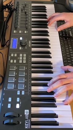 a person playing an electronic keyboard with their hands