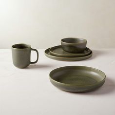 two cups and saucers on a white table