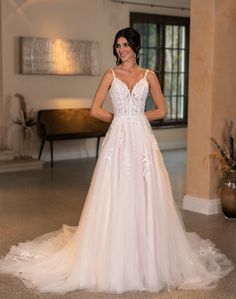 a woman in a wedding dress posing for the camera