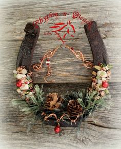 an old wooden sled decorated with christmas wreaths and pineconis on it