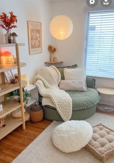 a living room with a green couch and white rugs on the hardwood flooring