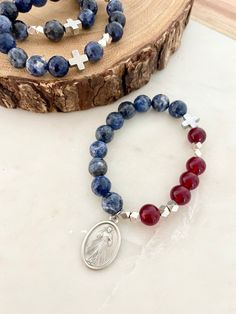 "Divine Mercy | Give Love + Blessings Rosary Prayer Bracelet | Classic Single Decade | Blue Sodalite | Red Jade | Jesus I trust in You  Medal: Divine Mercy  Reverse: Jesus I Trust In You Additional sizing upon request  Set comes with: 1 rosary stretch bracelet 1 jewelry pouch  1 Give Love + Blessings \"How to pray the rosary prayer bracelet\" Different Medal Request: All medals on bracelets can be interchanged upon request and availability. Please notate your medal request on note section at che Love Blessings, Give Love, Rosary Prayer, Praying The Rosary, Prayer Bracelet, Red Jade, Divine Mercy, Blue Sodalite, I Trust