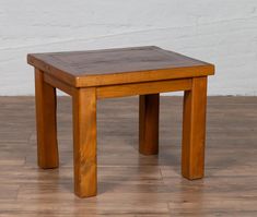 a small wooden table sitting on top of a hard wood floor