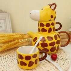 a ceramic giraffe cup and saucer sitting on a wicker place mat