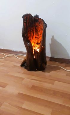 a wooden table that has some kind of fire in it's center and is on the floor