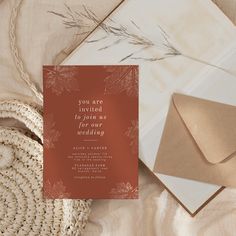 the wedding stationery is laid out next to an envelope