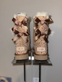 Custom Bling Ugg boots Bailey Bows has a hand placed bedazzled heel and back panel making this a perfect accessory for Weddings, birthday celebrations, or just a night out on the town. All boots are purchased from Ugg or authorized retailers. Size availability may vary depending on suppliers' current inventory. If the size or color needed is out of stock at the time of the order, we will notify you within 24 to 48 hours. If you are not sure about the size needed, please visit your closest retailer to try on for size. Excessive wear may result in embellishments coming off.   Turn around time is 4-6 weeks. If this item is needed before the turn around time, Please contact our shop before ordering. There will be an additional fee for Rush orders. **ALL ORDERS COME AS SHOWN IN PICS FOR ALL CUS Ugh Boots Bows, Custom Ugg Boots, Sparkling Winter Boots With Round Toe, Bling Leather Boots With Round Toe, Leather Boots With Bling And Round Toe, Leather Bling Boots With Round Toe, Sparkling Round Toe Wedding Boots, Bedazzled Party Boots For Winter, Winter Party Bedazzled Boots