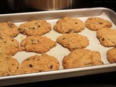 freshly baked oatmeal raisin chocolate chip cookies on a baking sheet in an oven