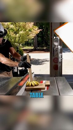 a man is using a table saw to cut wood