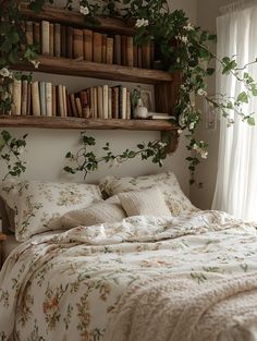 a bed with bookshelves above it and flowers on the headboard, in front of a window