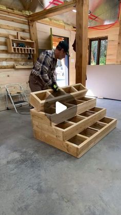 a man is working on some wooden boxes