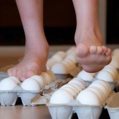 a person standing on top of eggs in trays