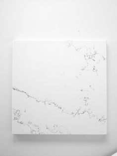 an abstract painting on a white wall with black and white paint splattered over it