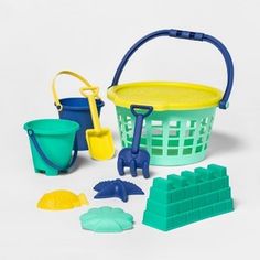 a toy bucket with shovels, sand and other toys