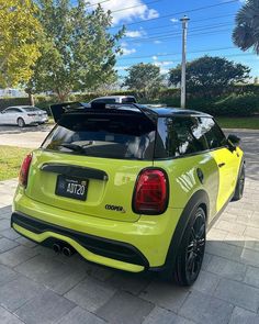 the rear end of a lime colored mini cooper