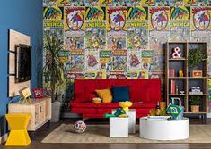 a living room filled with furniture and wallpaper covered in comic book covers on the walls