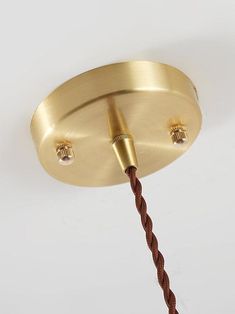 a close up of a light fixture with two lights on each side and a cord attached to it