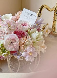 a bouquet of flowers sitting on top of a sink