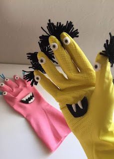 two hand puppets with eyes and mouths on them, one is pink and the other is yellow