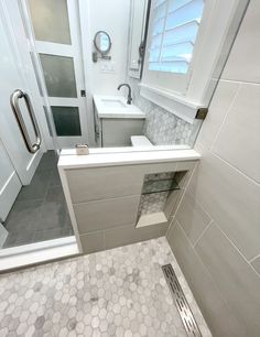 a bathroom with a toilet, sink and shower stall is shown in this image from the front view