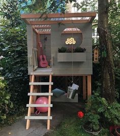 a small tree house with a ladder up to it