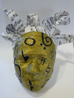 a paper mache mask with music notes on it