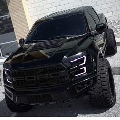 a black truck parked in front of a building